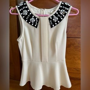 Cream peplum top with beaded neckline
